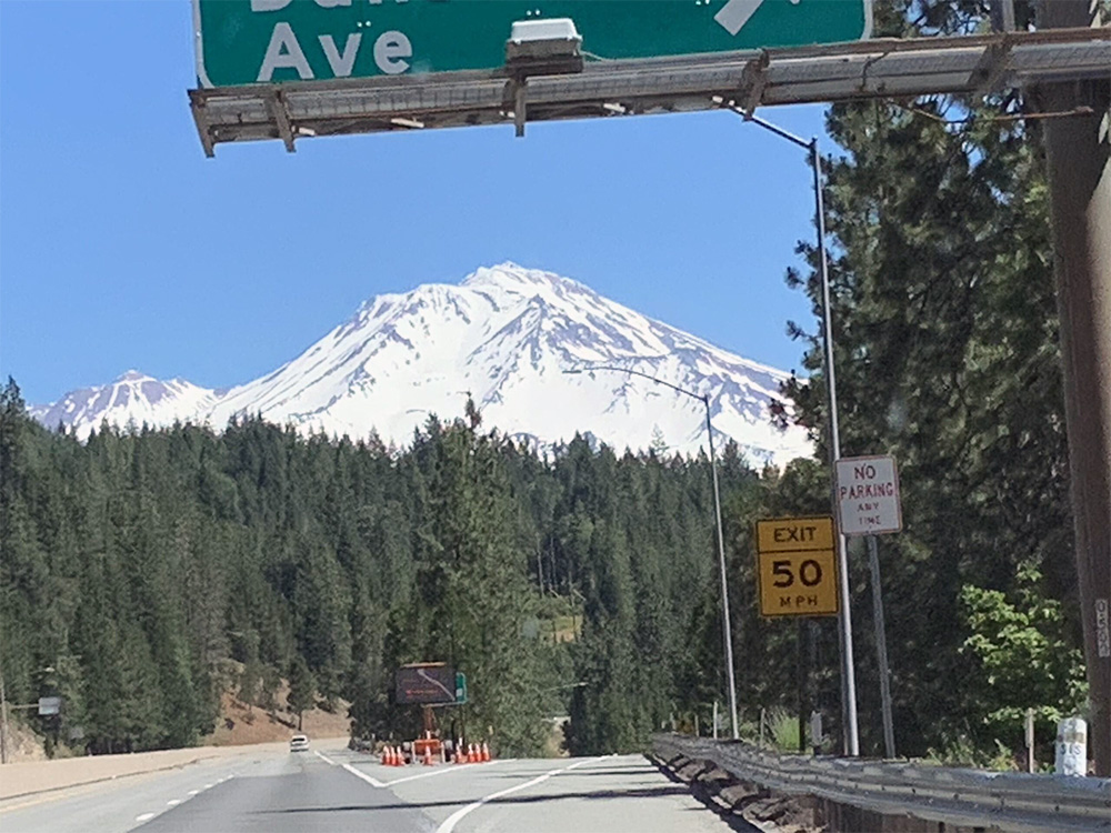 The view of Mount Shasta from I-5 in Northern California through my front windshield.